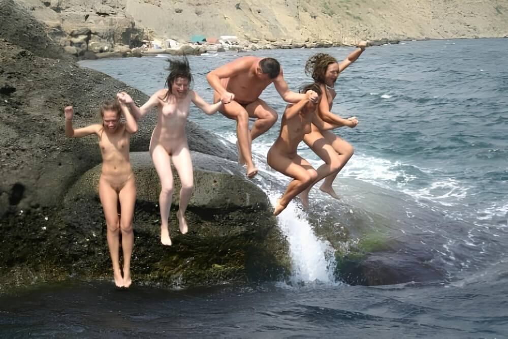 Mens and girls nudists on a beach - Naturism as a lifestyle and a way to connect with nature