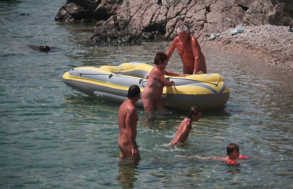 Lone Nudist in Yellow Boat photos - Naturists live in harmony and tranquility